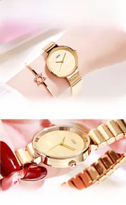 Detail view of gold quartz watch with bamboo link band and star bracelet on wrist