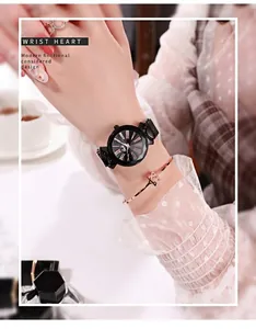 Close-up of rose gold starry dial watch and star bracelet on a woman wrist