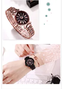 Detail of rose gold starry sky dial watch with Roman numerals and metal link bracelet