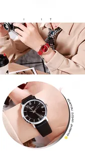 Close-up of retro ladies watch with Roman numerals and red leather strap in cafe setting