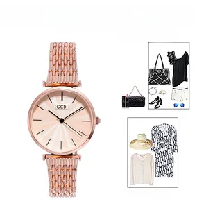 Close-up of rose gold mesh strap watch dial with minimalist sunray pattern texture