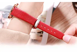 Detailed macro view of the red lychee pattern leather strap and buckle of the GEDI watch