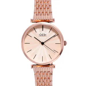 Minimalist rose gold women's steel watch with sunray dial and sleek metal link band