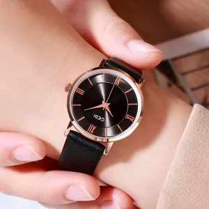 GEDI women's watch with rose gold case, Roman numerals and black leather strap on wrist