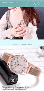 Detail of GEDI women's rose gold mesh watch with minimalist silver dial and magnetic strap