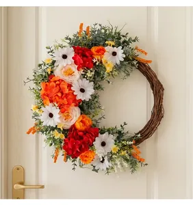 Close-up of faux flower wreath with white daisies and red hydrangeas on wooden door