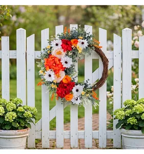 Detail of a floral wreath with faux tulips and daisies on a rustic vine base outdoors