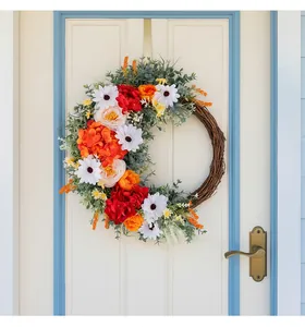 Close-up of artificial rose wreath with silk flowers on a woven rattan base for door decor