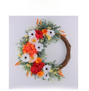 Front view of decorative floral wreath with silk roses and daisies on vine base