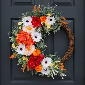 Artificial flower wreath with roses and daisies on a natural rattan base for home decor