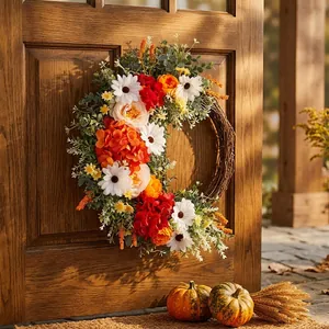Autumn artificial wreath with white daisies and orange roses on a rustic wooden door