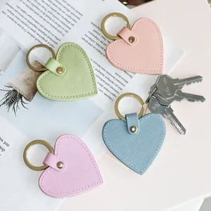 Set of four heart-shaped leather keychains in pastel colors with golden metal rings