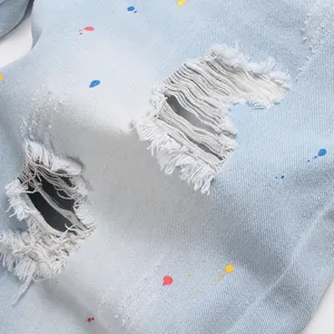 Men's light blue slim fit denim shorts with paint splatter and distressed ripped detail