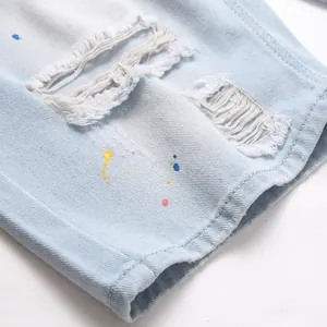 Men's light blue slim fit denim shorts with artistic paint splatters and distressed holes