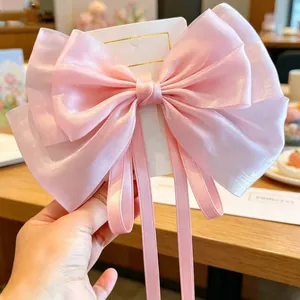Elegant large pink pearlescent ribbon bow hairclip for girls with long flowing streamers