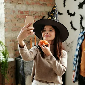 Detail of adult witch hat with gold foil pumpkin and cat patterns for party wear