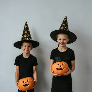 Close-up of black witch hats with gold foil prints worn by children with pumpkin props