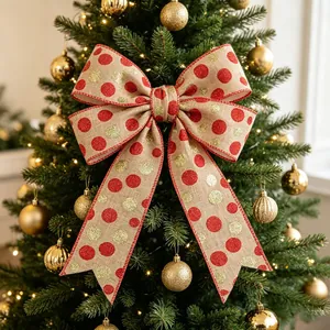 Detailed view of burlap Christmas bow with red and gold sequins on holiday tree