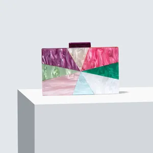 Macro detail of acrylic evening clutch featuring marble texture and geometric patchwork