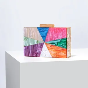 Detail of colorful acrylic evening clutch bag featuring marble texture and geometric patterns