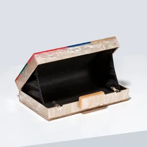 Detail of acrylic evening bag featuring marble texture and colorful mosaic edge design