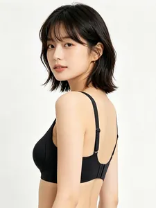 Detail view of the seamless black bra with adjustable straps and textured side panels