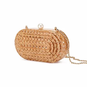 Oval woven rattan evening clutch bag with pearl clasp and gold chain strap