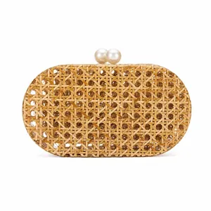 Detail of hand-woven oval rattan evening bag with elegant double pearl clasp closure