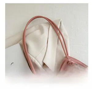 Detail of pink cherry print tote bag featuring a knotted handle and transparent mesh