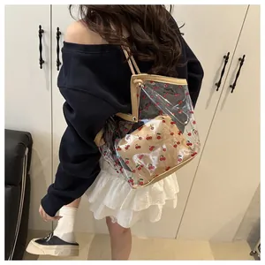 Detail of transparent PVC tote bag with cherry prints and matching inner pouch