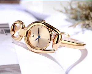 Macro detail of GEDI gold bracelet watch with minimalist sunray dial and blue hands