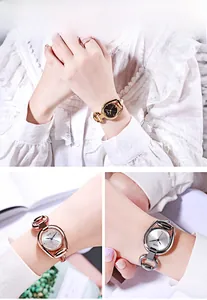 Close-up of elegant horseshoe-shaped fashion quartz watches in gold and silver finishes