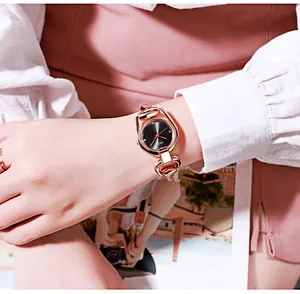 Detailed view of GEDI rose gold bracelet watch with horseshoe links and black dial