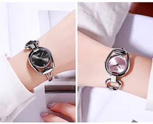 Detail of silver horsebit quartz watches featuring sunburst black and pink dials
