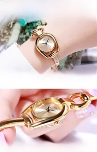 Detail of luxury gold quartz watch with horseshoe case and high-strength mineral glass
