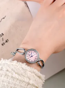 Close-up of GEDI women's watch with pink pearl dial, rhinestones, and hollow silver band