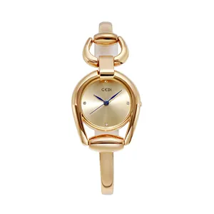 GEDI fashion women's gold bangle watch with horsebit case and blue pointers on sunray dial