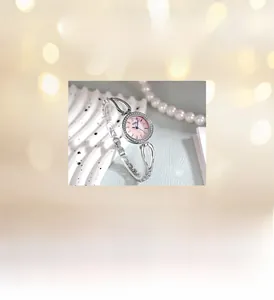 Detailed close-up of a luxury women quartz watch with pink dial and silver diamond bezel