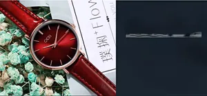Detailed macro view of the deep red sunburst watch dial with a polished rose gold case