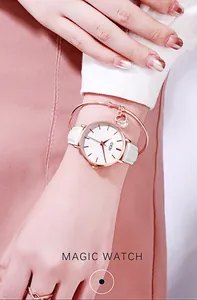 Elegant rose gold watch with white leather strap paired with a heart charm bracelet