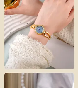 Close-up of GEDI ladies gold watch with crystal bezel and blue pearl dial on wrist