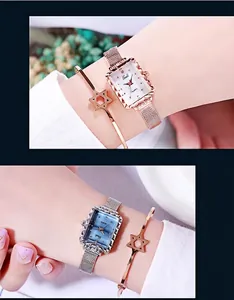 Dettaglio dell'orologio al quarzo rettangolare con cinturino mesh e bracciale stella