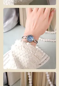 Elegant GEDI women's watch featuring a blue dial with diamonds and silver chain bracelet