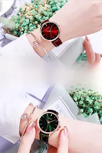 Close-up of GEDI leather watch set with sunburst dial and heart charm bracelet