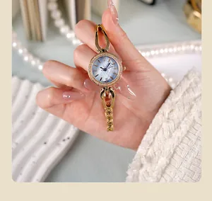Detail of luxury gold watch with blue mother-of-pearl dial and diamond-set bezel