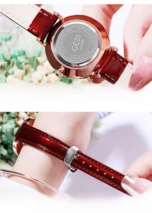 Detail of reddish-brown leather strap and rose gold stainless steel watch case back