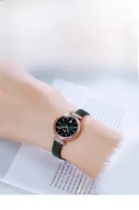 Elegant rose gold women's watch with green dial and leather strap worn on wrist
