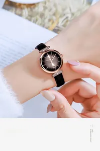 Detail of rose gold quartz watch with black sunray dial and calendar display
