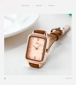 Detail view of rectangular rose gold quartz watch with malachite texture dial and leather strap