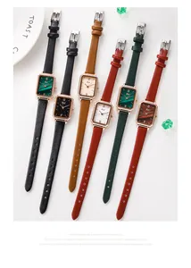 Close-up of elegant vintage rectangular watches with assorted leather straps and malachite dials